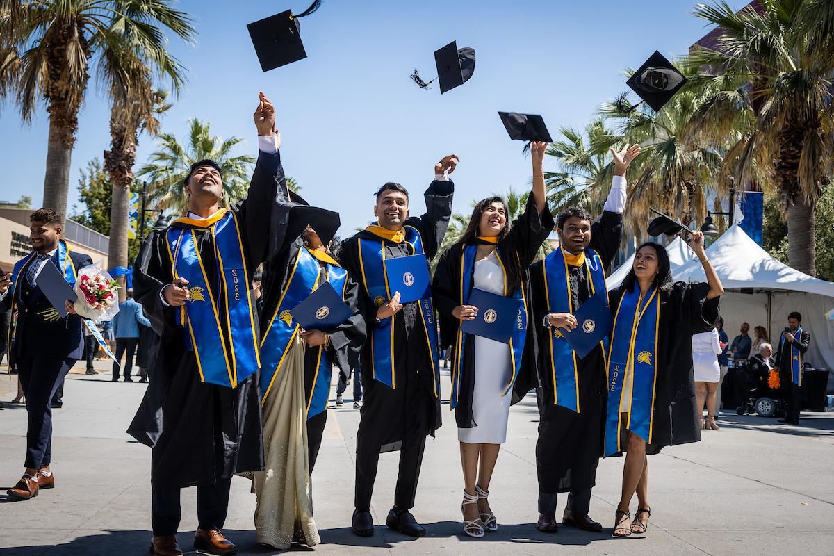 Grads throwing caps